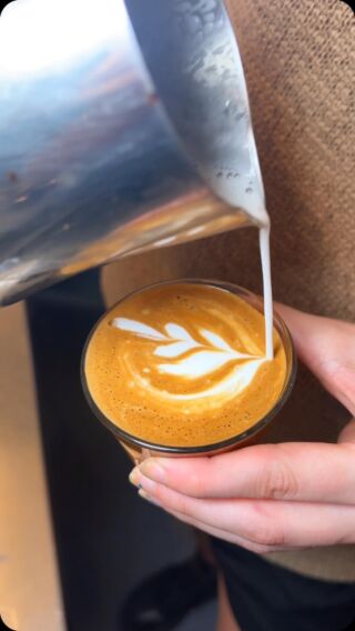 Barista pouring milk
